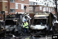 An official works at the scene of an antisemitic arson attack in the Golders Green neighborhood of north London, on March 24, an incident where volunteer ambulances run by a Jewish organization were set on fire the previous night.