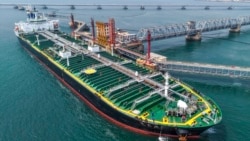 A tanker unloads imported crude oil at a terminal port in Qingdao, in China's Shandong Province, on June 25.
