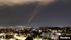 An anti-missile system operates after Iran launched drones and missiles toward Israel, as seen from Ashkelon, on April 14.