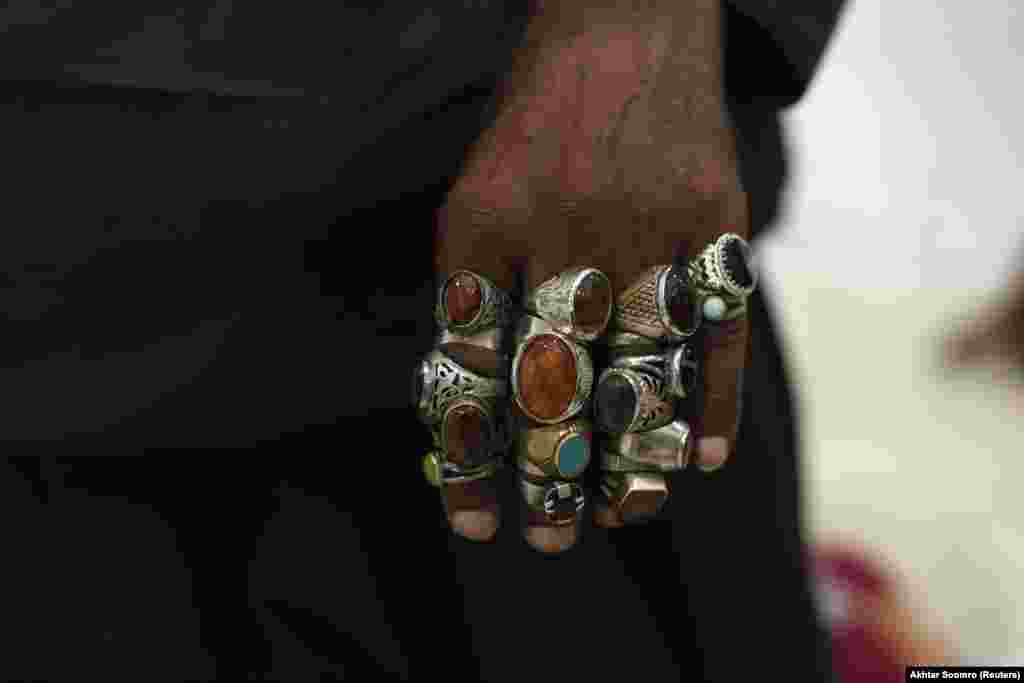 A devotee&#39;s hand is pictured decorated with rings inside the shrine. The annual festival is a spectacular parade of colorful clothing and personal decorations.&nbsp;