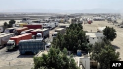 Cargo trucks wait at the Gabd-Rimdan border crossing in Pakistan's Balochistan Province on October 21, following the temporary suspension of trade between Pakistan and Iran.