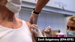 A man receives a shot of the Russian vaccine Sputnik V at a Budapest hospital on February 12