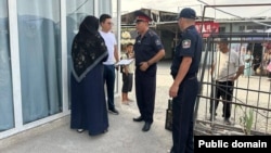 Policemen in Jalal-Abat take part in a campaign against the niqab.