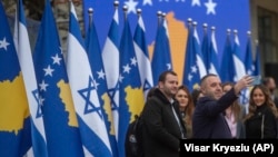 A Kosovo government official takes a selfie during a ceremony held digitally in Pristina on February 1.