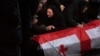 Relatives mourn during a farewell ceremony for Georgian volunteer Zurab Shvangiradze, who was killed during fighting in Ukraine, in Tbilisi on November 16.