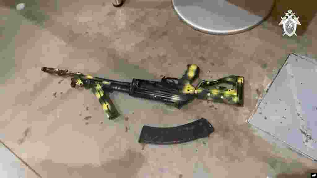 In this photo taken from video released by the Investigative Committee of Russia on March 23, a Kalashnikov assault rifle lies on the ground at the Crocus City Hall concert venue after the attack.