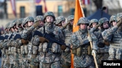 Soldiers take part in a military parade in Riga on November 18 to celebrate the 100th anniversary of Latvia's declaration of independence in 1918.