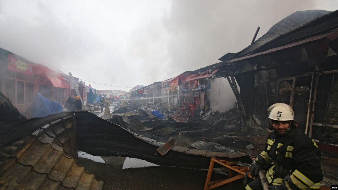 Firefighters work at a marketplace, which was set on fire after a terrorist attack in Grozny on December 4.