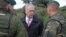 U.S. Defense Secretary James Mattis (center) talks with a German (right) and a Lithuanian soldier as he meets with U.S. troops deployed in Lithuania and other NATO troops on May 10.