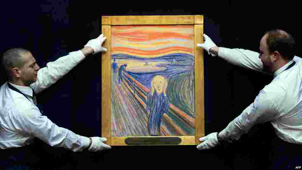 Sotheby's employees pose with Norwegian artist Edvard Munch's 1895 pastel-on-board version of "The Scream," which went up for auction in London on May 2. 