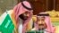 Saudi Crown Prince Mohammed bin Salman, left, speaks to his father, King Salman, right, at a meeting of the Gulf Cooperation Council in Riyadh, Saudi Arabia, Sunday, Dec. 9, 2018. 