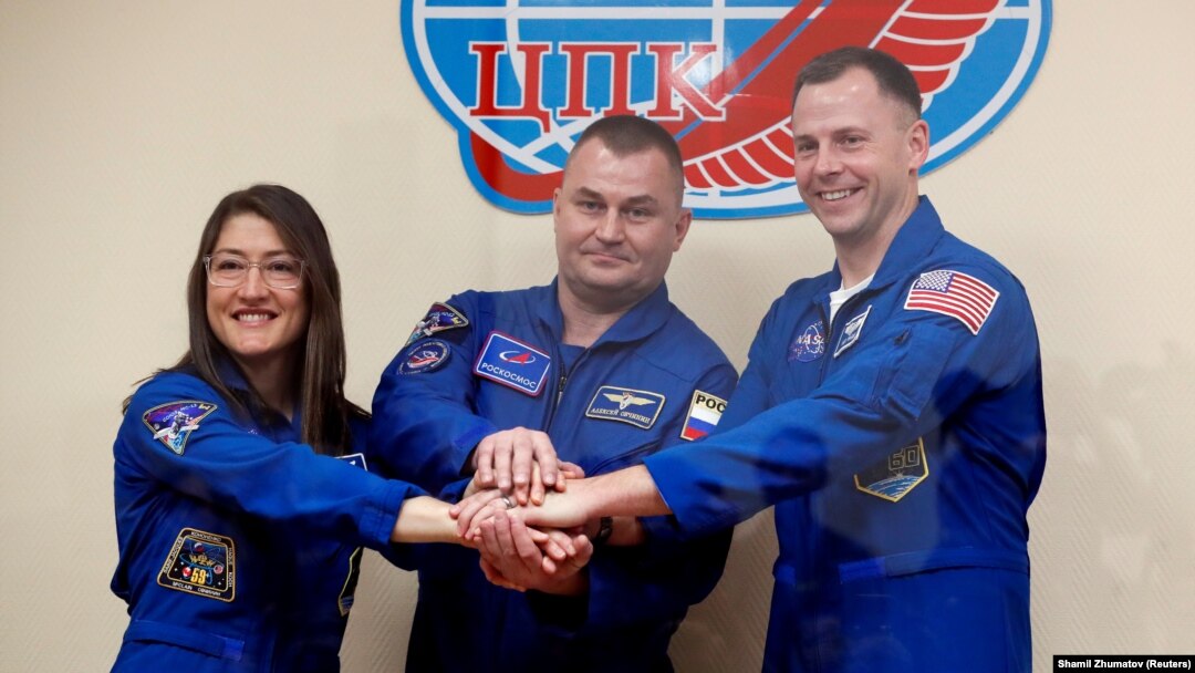 U.S. astronauts Christina Koch and Nick Hague and Russia's Aleksei Ovchinin (center) pose before their launch.