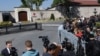 Members of the media wait outside the Turkish Presidency's Dolmabahce working office in Istanbul