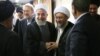 President Hassan Rouhani shaking hands with Amoli Larijani, with Ali Larijani on the left. Undated. File photo