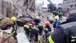 In this photo provided by the National Police of Ukraine, emergency services work on June 28 near a popular pizza restaurant destroyed by a Russian attack in Kramatorsk.