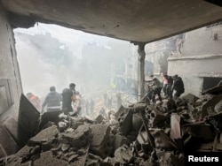 Rescuers work at the site of a reported Israeli strike in Beirut's Jnah area on April 5.