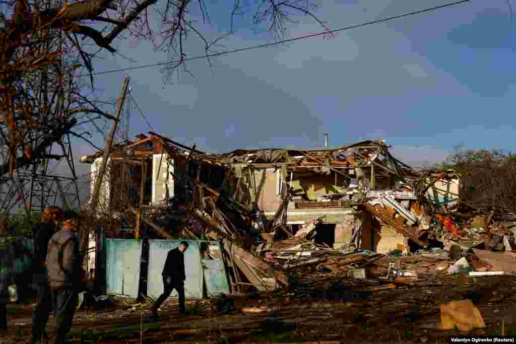Жителі Вишгорода дивляться на зруйнований внаслідок російської атаки приватний будинок, де загинув 14-річний підліток. Вишгород, Київська область, 30 вересня 2026 року