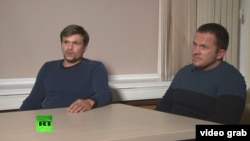 Two men later identified as Anatoly Chepiga and Aleksandr Mishkin appear on RT in September 2018 to discuss charges in Britain that they were involved in the Novichok poisoning.