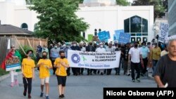 Canadians join an interfaith march following the killings of a Muslim family in an attack police have called a hate crime.