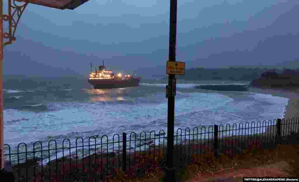 The Russian cargo ship Kuzma Minin is shown after she ran aground off the southwestern English coast near Falmouth in Cornwall. Reuters says the 180-meter ship, with 18 Russian crew on board, dragged its anchor in strong winds and then ran aground. There is no cargo on board. (Twitter @Alexandriapesic via Reuters)