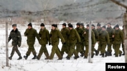 Newly mobilized Ukrainian soldiers march as they take part in training at the 169th training center of Ukrainian ground forces "Desna" in the Chernihiv region on February 13.