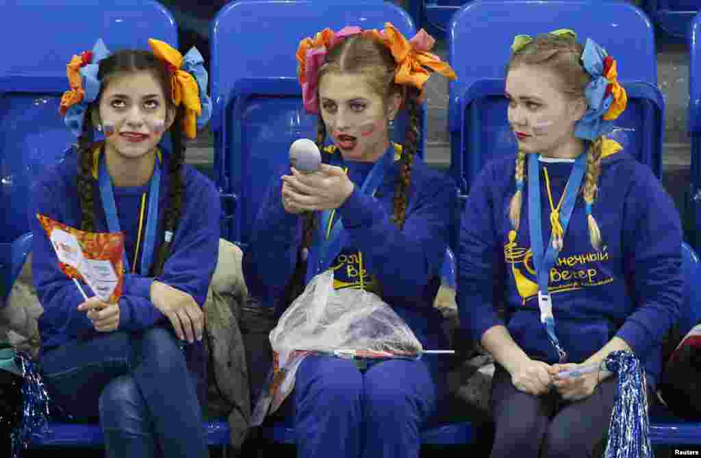 Spectators sit in the stands ahead of the women&#39;s ice hockey game between Russia and Germany.