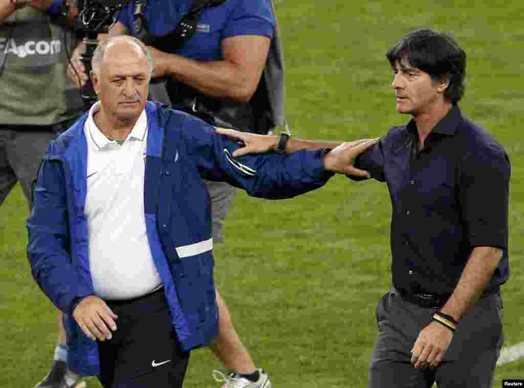 Brazil - Brazil's coach Luiz Felipe Scolari (L) congratulates Germany's coach Joachim Loew after Germany won their 2014 World Cup semi-finals at the Mineirao stadium in Belo Horizonte July 8, 2014. REUTERS/David Gray (BRAZIL - Tags: SOCCER SPORT WORLD CU