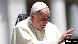 Vatican -- Pope Francis waves as he leaves after his weekly audience in St.Peter's square, at the Vatican City, May 13, 2015. 