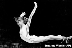 Nadia Comaneci dismounts from the uneven parallel bars to score a perfect 10 in the women's gymnastics competition at the 1976 Summer Olympics in Montreal.