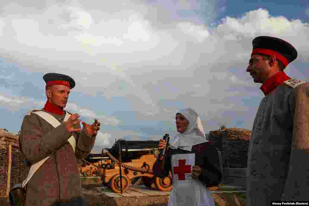 Actors chat inside the full-scale replica of the fort built on the site.