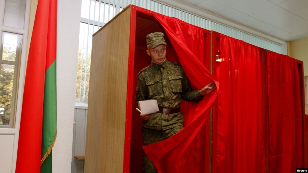 A soldier leaves a voting booth in Minsk to cast his ballot during early voting for Belarus's parliamentary elections.