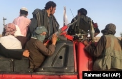 Taliban fighters ride in a vehicle in the Surkhroad district of Nangarhar Province.
