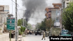 Smoke rises from an area where explosions and gunshots were heard in Jalalabad on July 28.