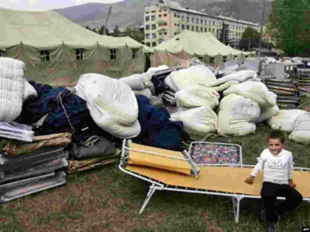 GEORGIA, TSKHINVALI : A South Ossetian girl sits on a folding bed in the camp of the Russian Emergencies Ministry on August 12, 2008 in Tskhinvali. SO08