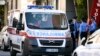 KOSOVO -- Kosovo police officers stand near an ambulance in front of the Ministry of Infrastructure in Pristina, October 13, 2019