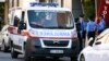 KOSOVO -- Kosovo police officers stand near an ambulance in front of the Ministry of Infrastructure in Pristina, October 13, 2019