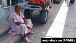 Turkmenistan. women sits at road-side