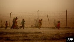 Syrian children at a temporary refugee camp in Syria