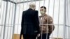 Stsyapan Latypau in a defendant's cage during his trial in Minsk earlier this summer. 