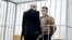 Stsyapan Latypau in a defendant's cage during his trial in Minsk earlier this summer. 