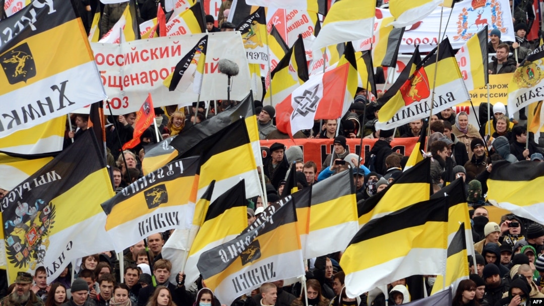 Russian ultranationalists wave tsarist black-yellow-white flags as they take part in the "Russian March" in central Moscow in November 2012.