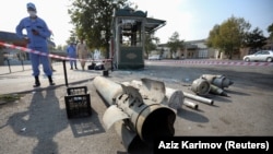 An Azerbaijani investigator stands near shell fragments in the town of Barda on October 29, 2020.