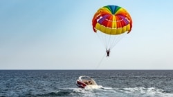 Parasailing colorful parachute motorboat