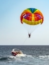 Parasailing colorful parachute motorboat