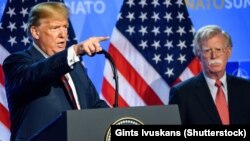 U.S. President Donald Trump (left) is flanked by national-security adviser John Bolton during a press conference after a summit at NATO headquarters in Brussels in July 2018.