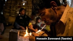 Iran -- A drug addict in Sistan & Balouchestan province using drugs in front of his family. December 20, 2015.