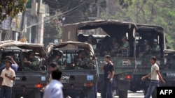 Bangladeshi soldiers gather outside the Bangladesh Rifles headquarters in Dhaka on February 25.