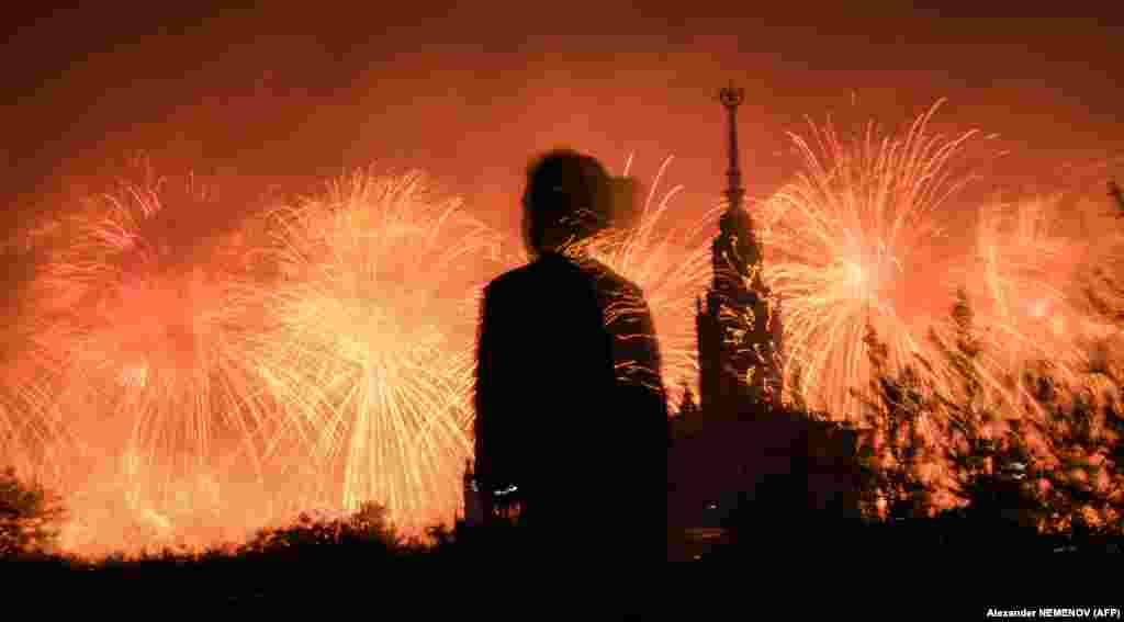 A girl watches fireworks exploding behind Moscow State University during celebrations on June 24 marking the 75th anniversary of the Soviet victory over Nazi Germany in World War Two. (AFP/Alexander Nemenov)