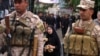 Iraqi soldiers stand guard during the religious ceremony of Ashura in the holy city of Karbala on November 3.