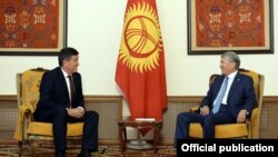 Kyrgyz President-elect Sooronbai Jeenbekov (left) sits with outgoing President Almazbek Atambaev.